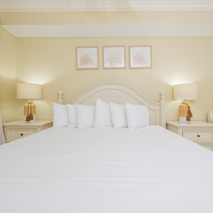 Experience serene relaxation in the plush king bedding, perfectly inviting you to unwind after a day by the coast