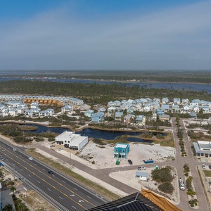 This view showcases a vibrant landscape with charming homes and a serene waterway, perfect for a relaxing getaway