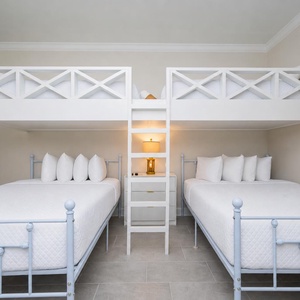 Enjoy a fun stay in this guest room featuring two loft twins over two queen beds and stylish lighting
