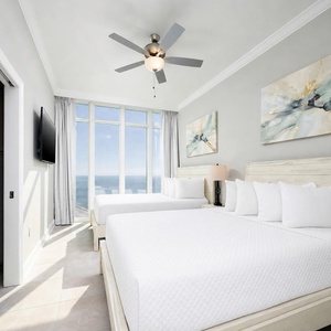 Wake to a breathtaking sunrise in this queen guest suite with two cozy beds and expansive views from the windows