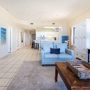 Unwind in the spacious living area featuring a sofa with queen sleeper and a view into the kitchen and dining space