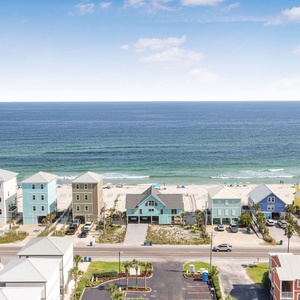 This stunning beach view showcases colorful beachfront homes, inviting guests to relax and enjoy the coastal atmosphere