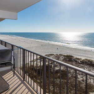 Enjoy stunning beachfront views from the balcony, complete with a table and chair for relaxation