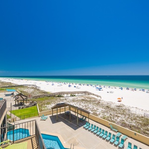 Lounge on your balcony soaking in warmth while watching colorful umbrellas dot the coast