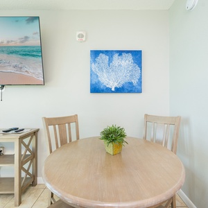 The dining area invites you to enjoy meals while watching waves shimmer beyond your balcony door