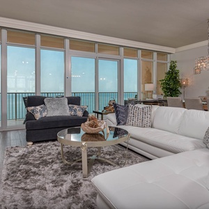 Relax on the sectional enjoying stylish decor and gaze at the coast through floor-to-ceiling windows