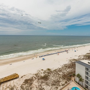 Step onto the wooden boardwalk, feel the gulf breeze, and watch rows of umbrellas dot the shoreline