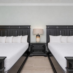 Drift off to sleep in this peaceful guest room with dual queens, fluffy pillows, and a relaxing vibe