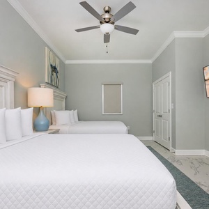 Tranquil guest bedroom featuring two comfortable queen beds with soft linens and a relaxing vibe