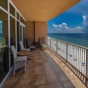 Relax on the spacious balcony, enjoying comfortable seating and breathtaking views of the tranquil water below