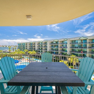 Relax on the balcony while soaking up the bay view from this inviting seating arrangement