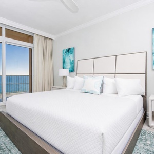 Retreat to the king master suite with cozy bedding and drift off to the sound of the waves from the balcony