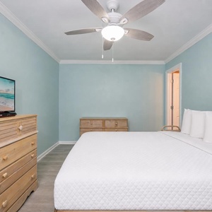 Rest and recharge in this serene guest suite with a queen bed, fluffy pillows, and coastal accents