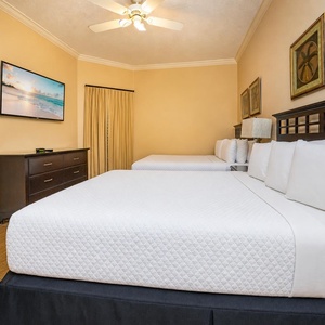 In the guest suite with two queens, unwind while enjoying your favorite shows on the flat screen TV