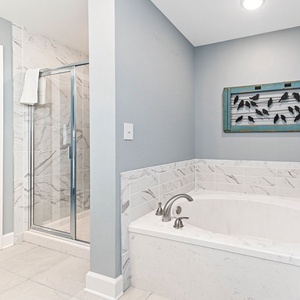Soak in the marbled-lined tub or refresh in the walk-in shower with elegant tile accents