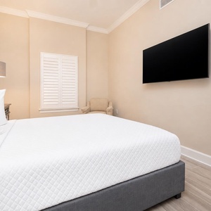 Unwind on the inviting queen bed surrounded by fluffy pillows and turn on the TV for a relaxing night