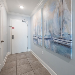 Step into a welcoming entryway adorned with nautical art, setting a relaxed tone for your beach getaway