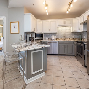 Cook and gather in this inviting kitchen featuring granite countertops, sleek appliances, and stylish bar seating