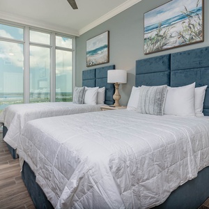 Wake to a stunning sights in this queen guest suite with two cozy beds and scenic views