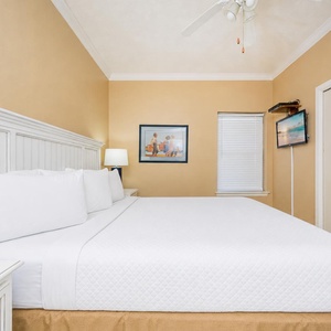 Rest in your king suite where gentle fan whispers and coastal scenes on the TV soothe your mind