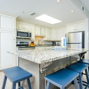 Inviting kitchen space with granite countertops, stainless appliances, and open design with an island