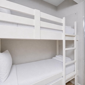 Discover the bunk bed area in the hallway, perfect for kids, with easy access to the bright living space and stunning views