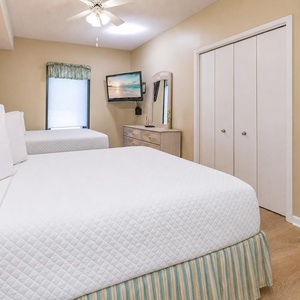 Two double beds in the guest suite offer restful comfort while you watch a movie