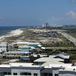 Relax on the balcony and observe the stunning coastline, beach below, and bands of dune grass swaying