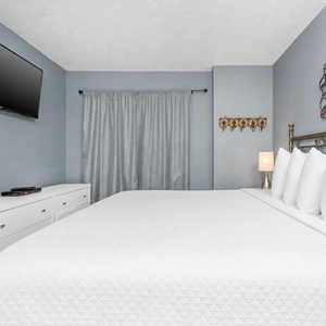 Relax after a day at the beach with your favorite shows in this soothing bedroom and drift into peaceful slumber