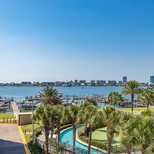 Breathe in the fresh coastal air from the spacious balcony while enjoying stunning views of the bay and lush greenery