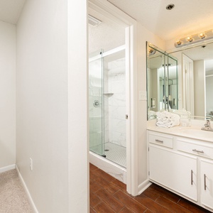 Refresh in the master bathroom, where plush towels await after a day of beachside fun and relaxation