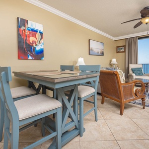 Enjoy meals at the stylish dining table, while the inviting living area offers a relaxing space with beach views