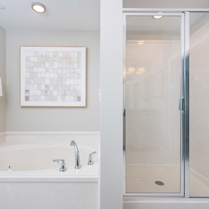 Indulge in relaxation with a soaking jetted tub and separate shower in the master bath, complemented by elegant decor