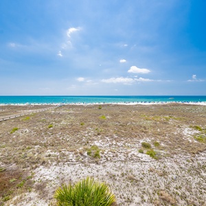 Savor the coastal breeze while lounging on your balcony, admiring vibrant beach views stretching to the horizon