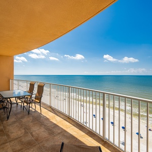Relax on the spacious balcony, enjoying the expansive view of the stunning shoreline below