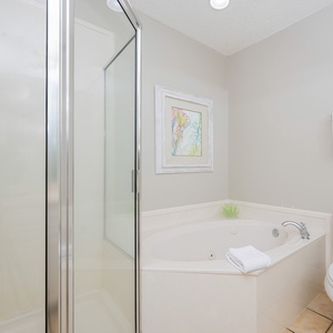 Indulge in relaxation in the master bath with a refreshing walk-in shower and soothing jetted tub