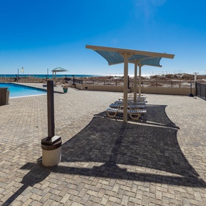 Relax by the poolside under shaded areas, enjoying refreshing views and easy access to the beach
