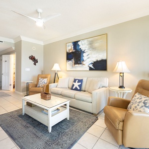 Soft sounds from ceiling fan hum as you settle into the living room's inviting sofa and leather chairs