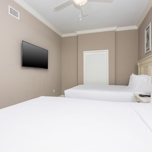 Relax on one of the cozy queen beds in this guest suite and stream your favorite shows after a beach day