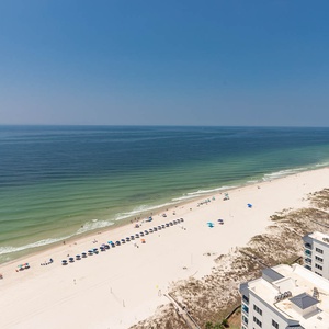 Stroll along the wide beach below, spotting orderly umbrellas and listening to the gulf's gentle surf