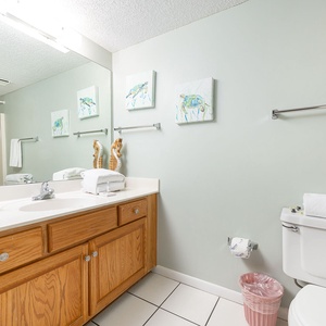 Experience refreshment in the guest bathroom, where plush towels await after a day of beach adventures