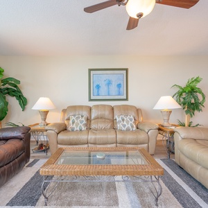 Relax in the comfortable living room, enjoying quality time with loved ones amidst beach decor