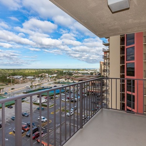 Enjoy panoramic views from the spacious balcony overlooking lush greenery and vibrant city life