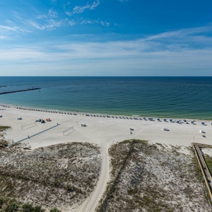 Take in the expansive view of the tranquil water and beach, perfect for relaxing and enjoying the coastal atmosphere