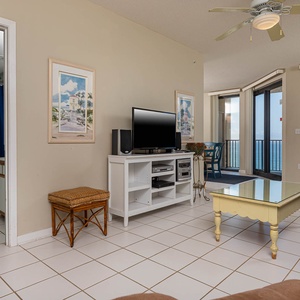 Relax in the inviting living area, featuring comfortable seating, a TV, sofa with queen sleeper, and beachfront views
