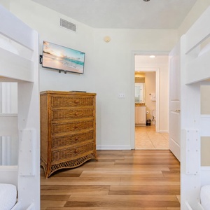 Twin bunk beds frame your view of the guest bath as you unwind and stream your favorite shows in this guest suite
