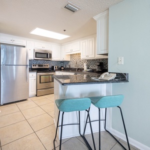 Enjoy casual meals at the sleek bar seating, surrounded by stylish decor in the kitchen