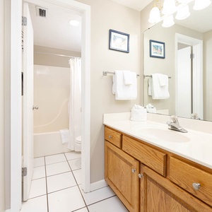 Refresh in this master bathroom featuring a spacious vanity, bright lighting, and a relaxing tub-shower combo