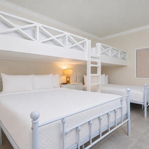 Experience comfort in this guest room with two twin loft bunk beds over two queen beds, perfect for families