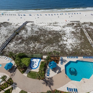 Enjoy the inviting pool area with lounge chairs and a splash pad, just steps away from the beach access